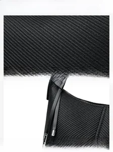 Detail of durable textured black fabric and premium metal zipper on a baguette bag