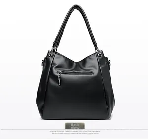 Back view of black pebble leather tote bag featuring a practical zipper pocket