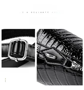 Detail of silver buckle and zipper closure on black faux crocodile leather shell bag
