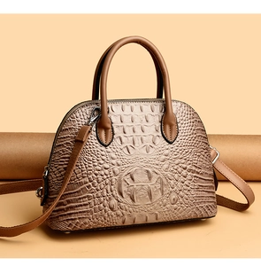 Detail shot of vintage khaki shell bag with luxury crocodile embossed texture and handles