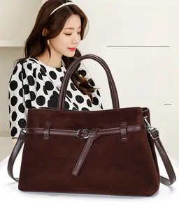 Brown frosted suede tote bag being carried by a model wearing a polka dot top