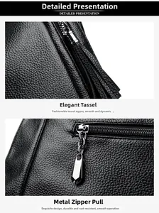 Close-up of black lychee grain leather tote bag with silver tassel and hardware zipper pull