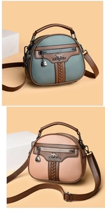 Detail of lychee pattern leather bags with front zip and kangaroo metal logo
