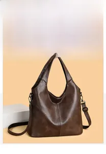 Detailed macro view of dark brown lychee texture leather tote with vertical stitching
