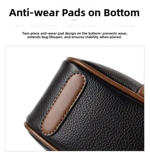 Detail of lychee pattern leather bag bottom with anti-wear pads and brown edge oil finish
