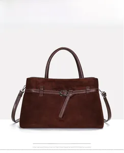 Detailed front view of dark brown suede tote bag with leather straps and silver metal buckles