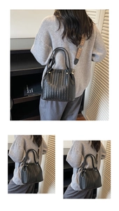 Close-up of black woven leather tote bag with jacquard strap and gold-tone hardware