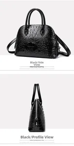 Detail view of black glossy crocodile embossed leather shell bag with top handles