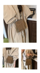 Detail of brown suede crossbody bag with vintage bronze kiss-lock and fringe tassels