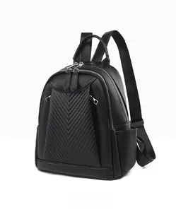 Close-up of black lychee grain leather backpack with V-shaped quilting and silver zippers
