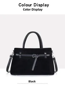 Detail view of black tote bag featuring matte texture and smooth leather strap buckle
