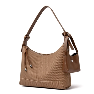 Brown woven baguette shoulder bag for women with a mini purse charm in retro casual style