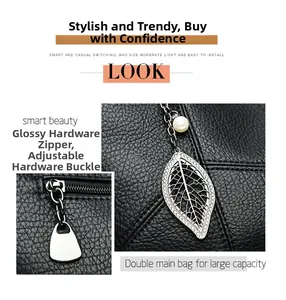 Détail du sac cabas en cuir noir avec pendentif feuille et double compartiment spacieux