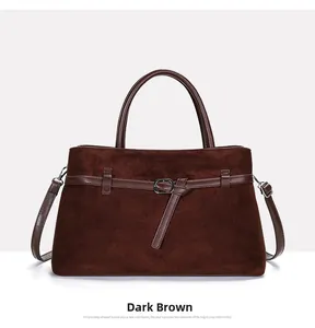 Detail of dark brown tote bag showing matte texture and silver metal buckle on leather strap