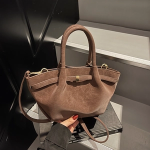 Retro dark brown matte leather wing bag with dual handles and gold hardware detailing