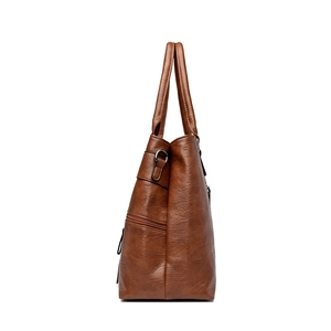 Vintage brown leather tote bag with side zipper pocket and elegant metallic details