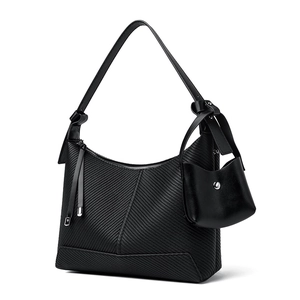 Minimalist black baguette shoulder bag with diagonal texture and mini coin purse charm