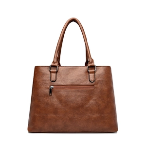 Brown faux leather tote bag with lychee texture and back zipper on white background