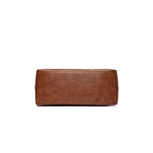 Bottom view of vintage brown leather tote bag with rectangular base and neat stitching