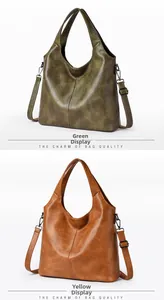 Detail view of premium leather hobo bags in olive green and caramel with metal hardware