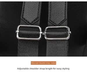 Detail of adjustable shoulder straps with silver buckles on a black pebbled leather backpack