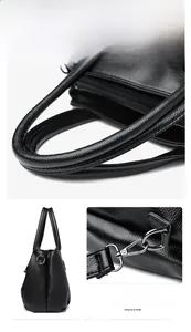 Détail de la poignée renforcée et des ferrures en métal poli sur le sac en cuir grainé noir