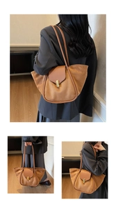 Detail of caramel suede tote bag featuring golden buckle and premium leather trim