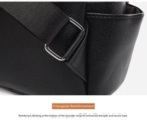 Detail of reinforced triangle stitching and silver square ring on a black leather backpack