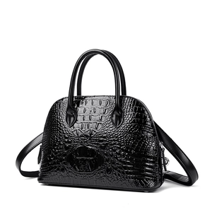 Retro black faux crocodile skin top handle shell bag with adjustable strap and glossy finish