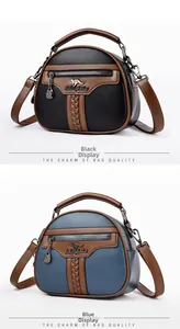 Close-up of black and blue textured crossbody bags with kangaroo logo and handle