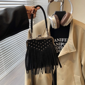Detail of black tassel handbag featuring silver studs and retro metal clasp closure