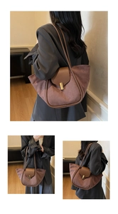 Brown suede tote bag detail featuring golden buckle and smooth leather patchwork