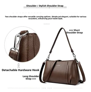 Detail of brown litchi grain leather texture and detachable silver metal hardware hooks