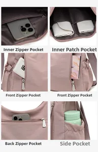 Detail view of pink Oxford cloth bag showing multi-pocket storage and durable zippers