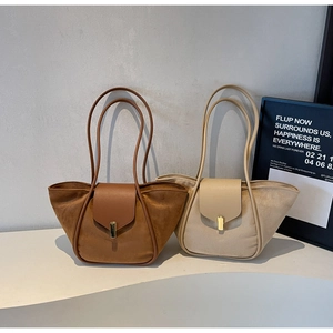 Detail of minimalist suede tote bags with golden metal buckles and leather trim details
