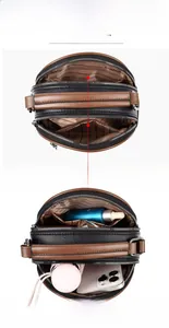 Detail of multi-layer cross-body bag interior showing large capacity and zipper pockets