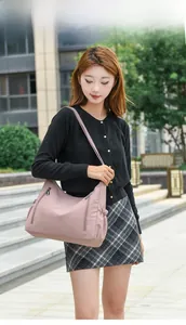 Outdoor shot of pink Oxford fabric crossbody bag with large capacity and multi-layers