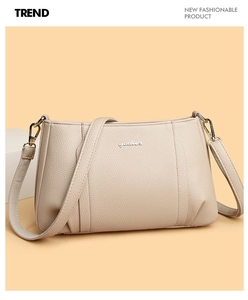 Close-up of beige crossbody bag with premium lychee grain leather and yadier logo