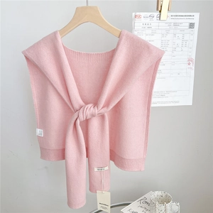 Close-up of pink 100% wool knitted shawl featuring delicate ribbed edges and tie-up design