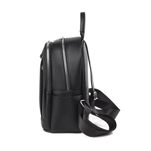 Side view of a black lychee texture leather backpack with silver zippers and top handle