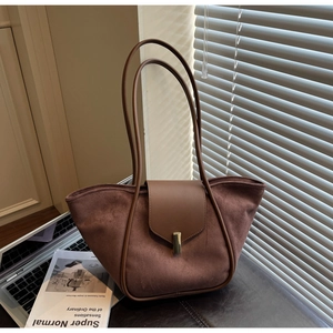 Detail of vintage brown suede tote bag with leather piping and gold metal lock buckle