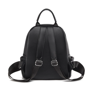 Minimalist black pebbled leather travel backpack featuring dual straps and side pockets