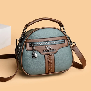 Blue semi-circle shoulder bag with textured leather and kangaroo logo in a 45-degree view