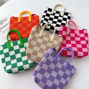 Checkerboard knit tote bags in six vibrant colors including orange and black and white