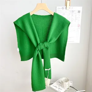 Close-up of vibrant green 100% wool knitted shawl featuring premium ribbed edges