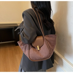 Detailed back view of a brown suede tote bag featuring a gold rectangular twist lock