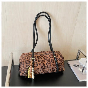 Detail of leopard print cylindrical shoulder bag with beaded fringe tassel and leather strap