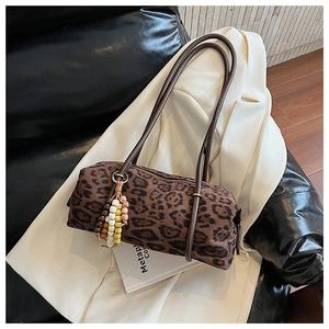 Macro shot of leopard print cylinder bag with colorful beads on a white blazer