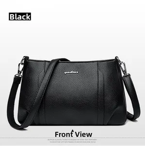 Front view of black pebbled leather handbag with silver logo and detachable strap