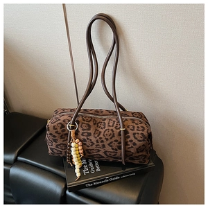 Detail of leopard print cylinder bag with beaded tassel and long shoulder straps